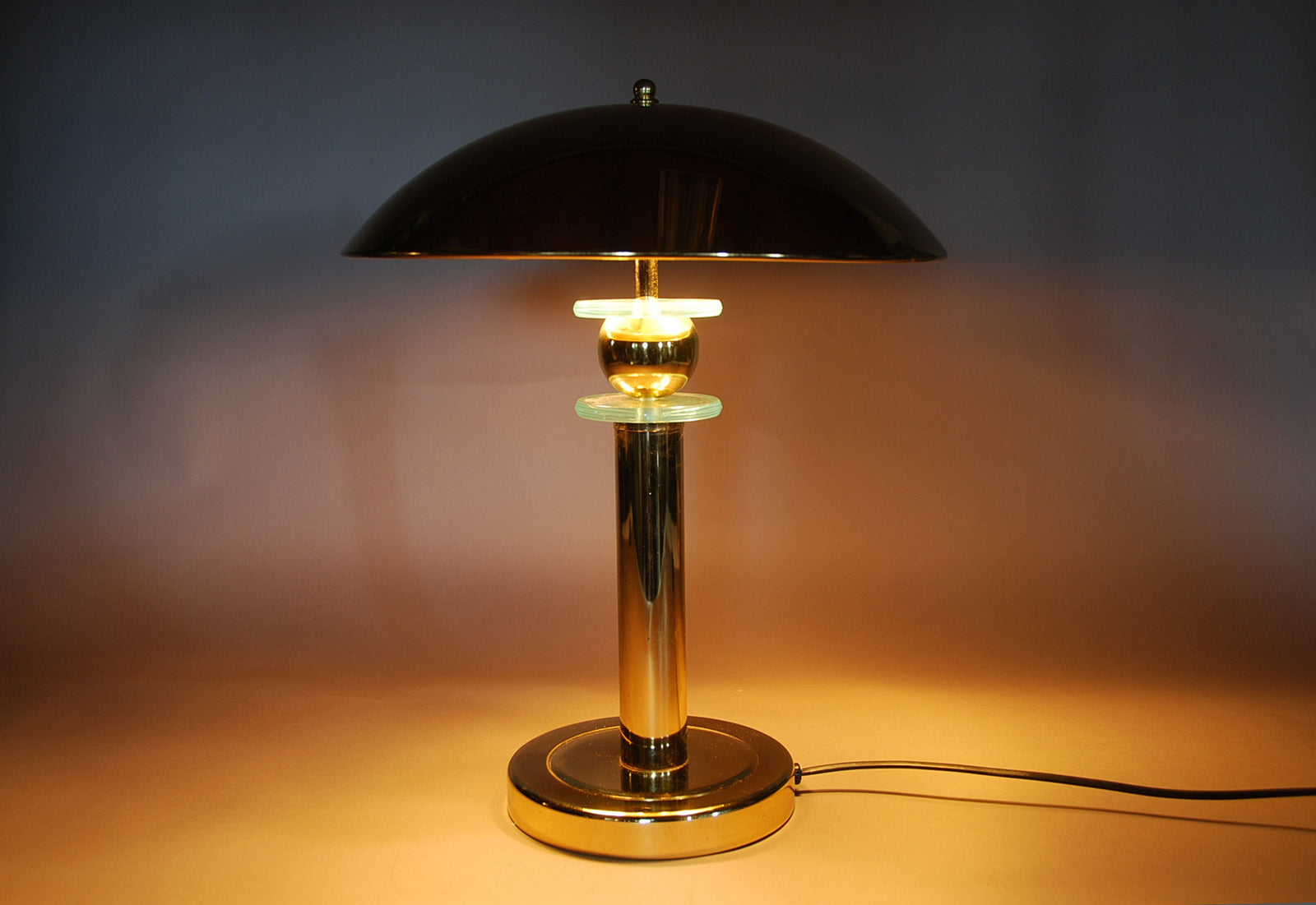 Elegant vintage mushroom lamp featuring a polished brass finish and a distinctive mushroom-shaped shade. This mid-century modern table lamp adds a touch of retro charm to any room, making it perfect for bedside tables, desks, or reading nooks. Its warm, ambient light creates an inviting atmosphere, while the compact design ensures it fits seamlessly into various interior spaces.