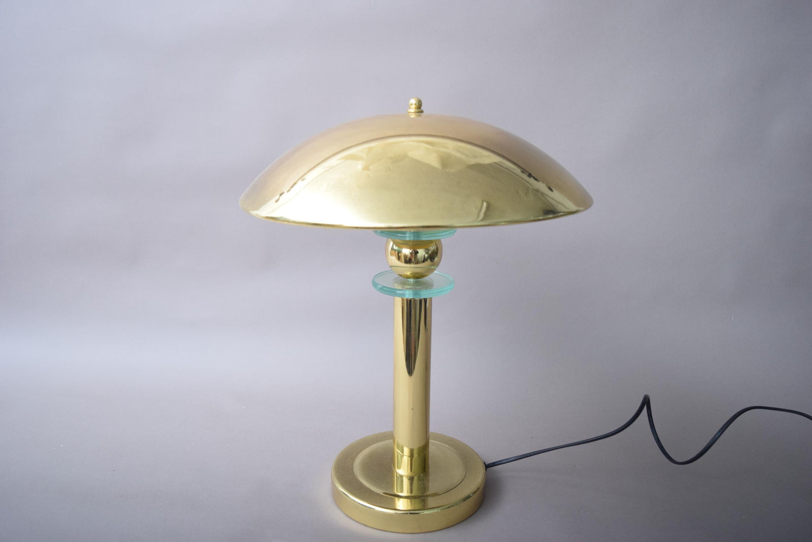 Elegant vintage mushroom lamp featuring a polished brass finish and a distinctive mushroom-shaped shade. This mid-century modern table lamp adds a touch of retro charm to any room, making it perfect for bedside tables, desks, or reading nooks. Its warm, ambient light creates an inviting atmosphere, while the compact design ensures it fits seamlessly into various interior spaces.