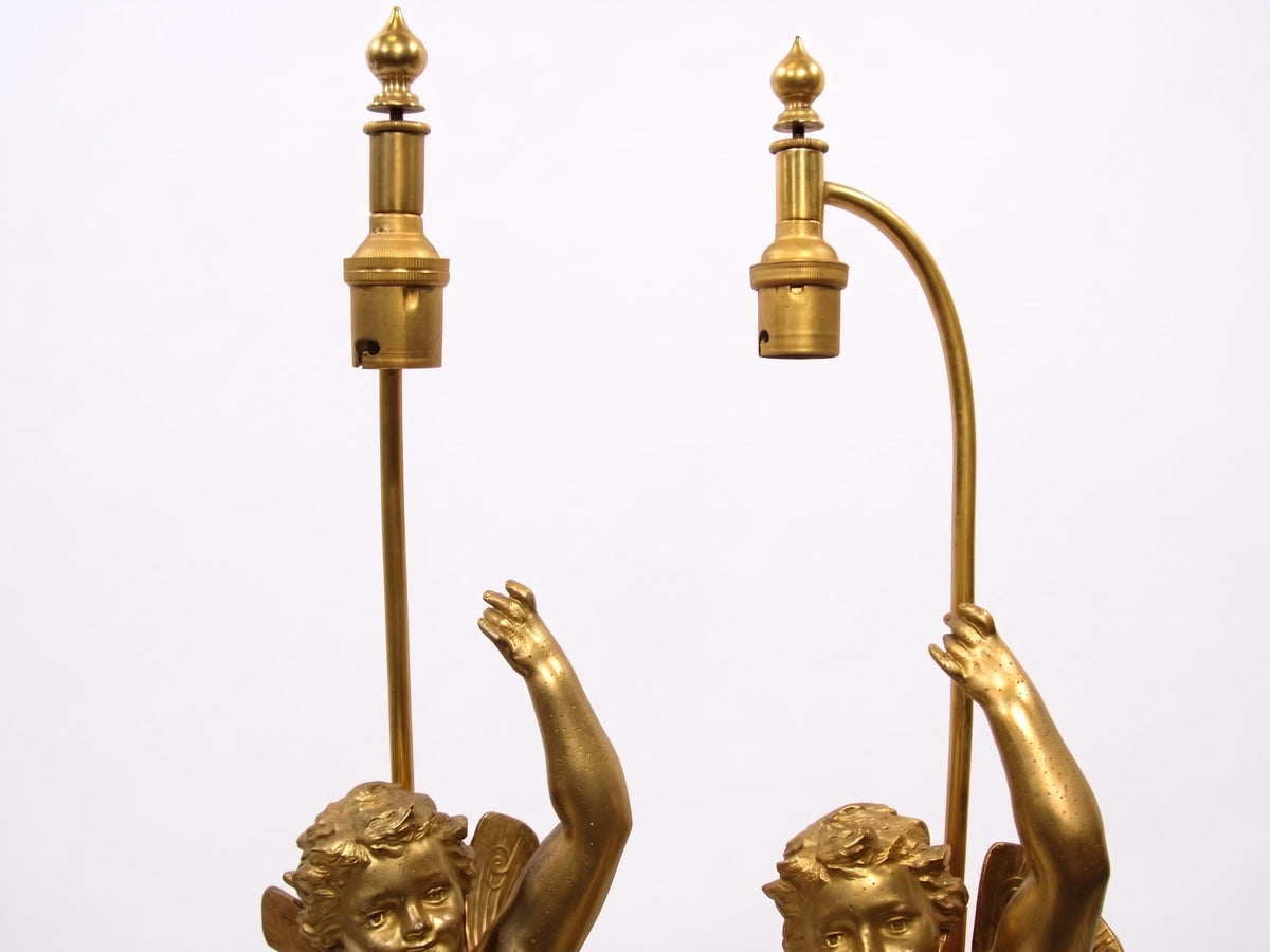 Pair of French Gilt Putti Table Lamps, Winged Cherub Figures on White Marble Bases — France, Early 20th Century