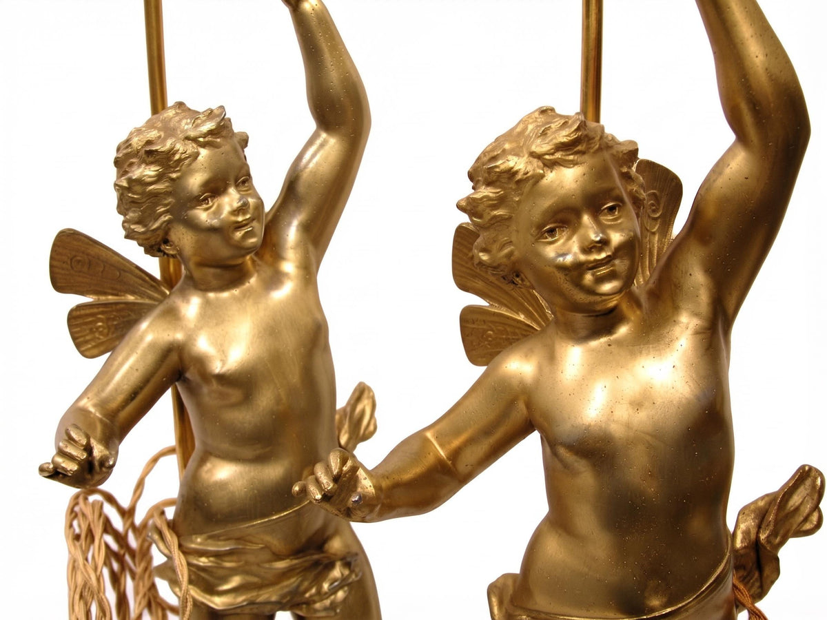 Pair of French Gilt Putti Table Lamps, Winged Cherub Figures on White Marble Bases — France, Early 20th Century