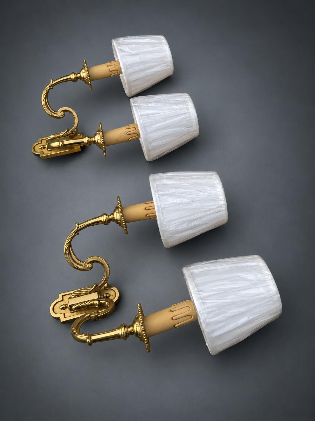 Pair of Gilt Metal Two-Arm Wall Sconces with Candle-Form Covers and Scrolled Arms