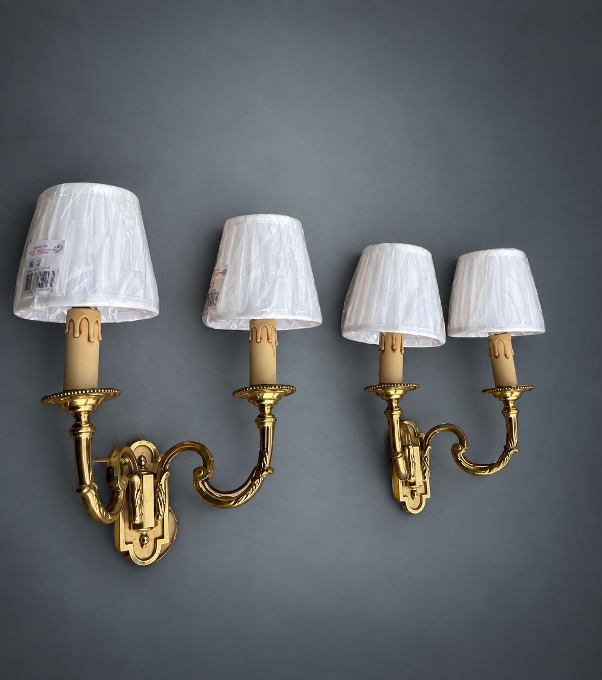Pair of Gilt Metal Two-Arm Wall Sconces with Candle-Form Covers and Scrolled Arms