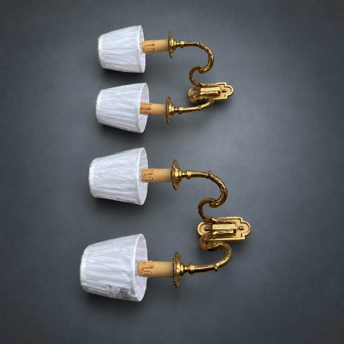 Pair of Gilt Metal Two-Arm Wall Sconces with Candle-Form Covers and Scrolled Arms