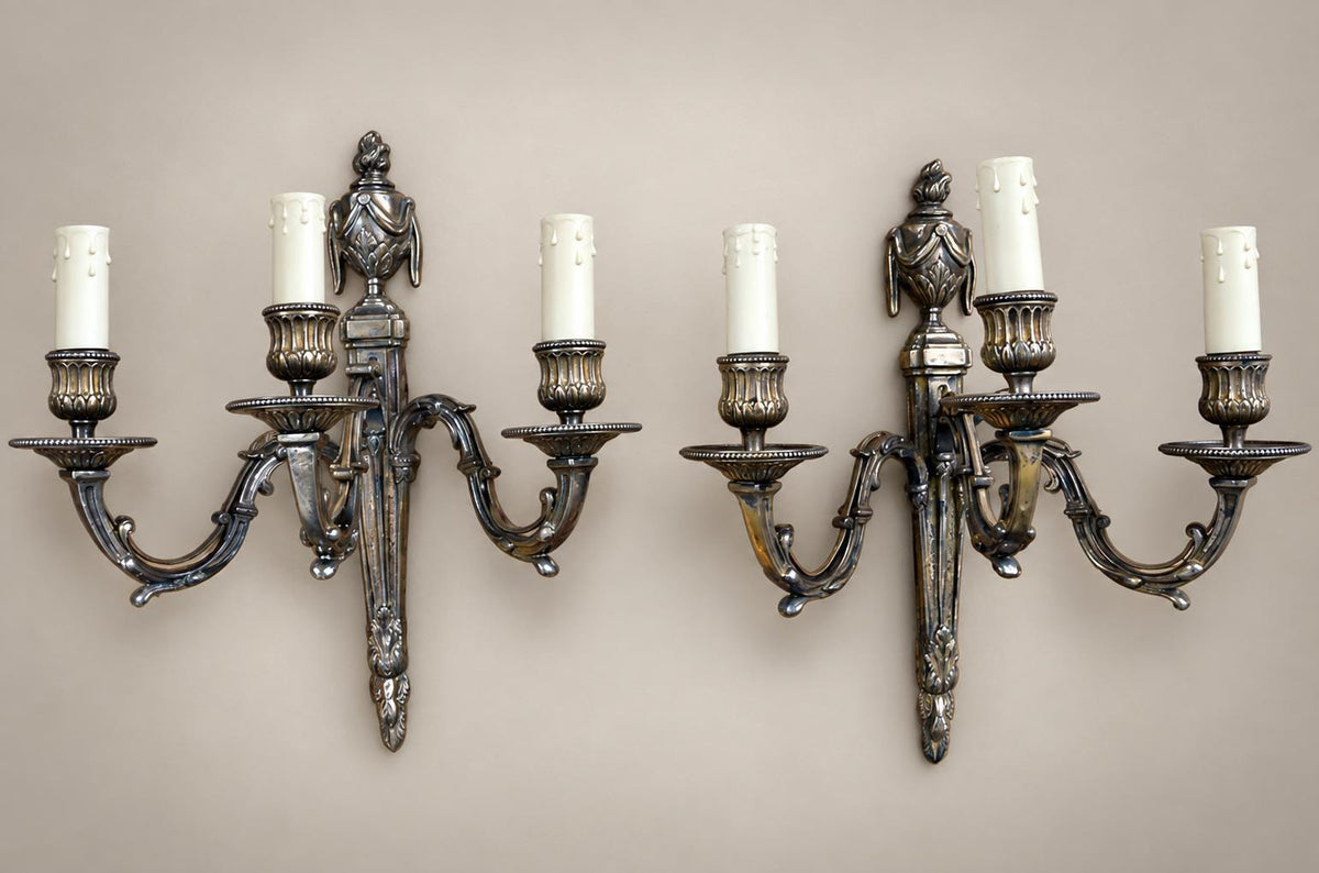 Pair of French Neoclassical Style Patinated Metal Three-Light Wall Sconces Mid 20th