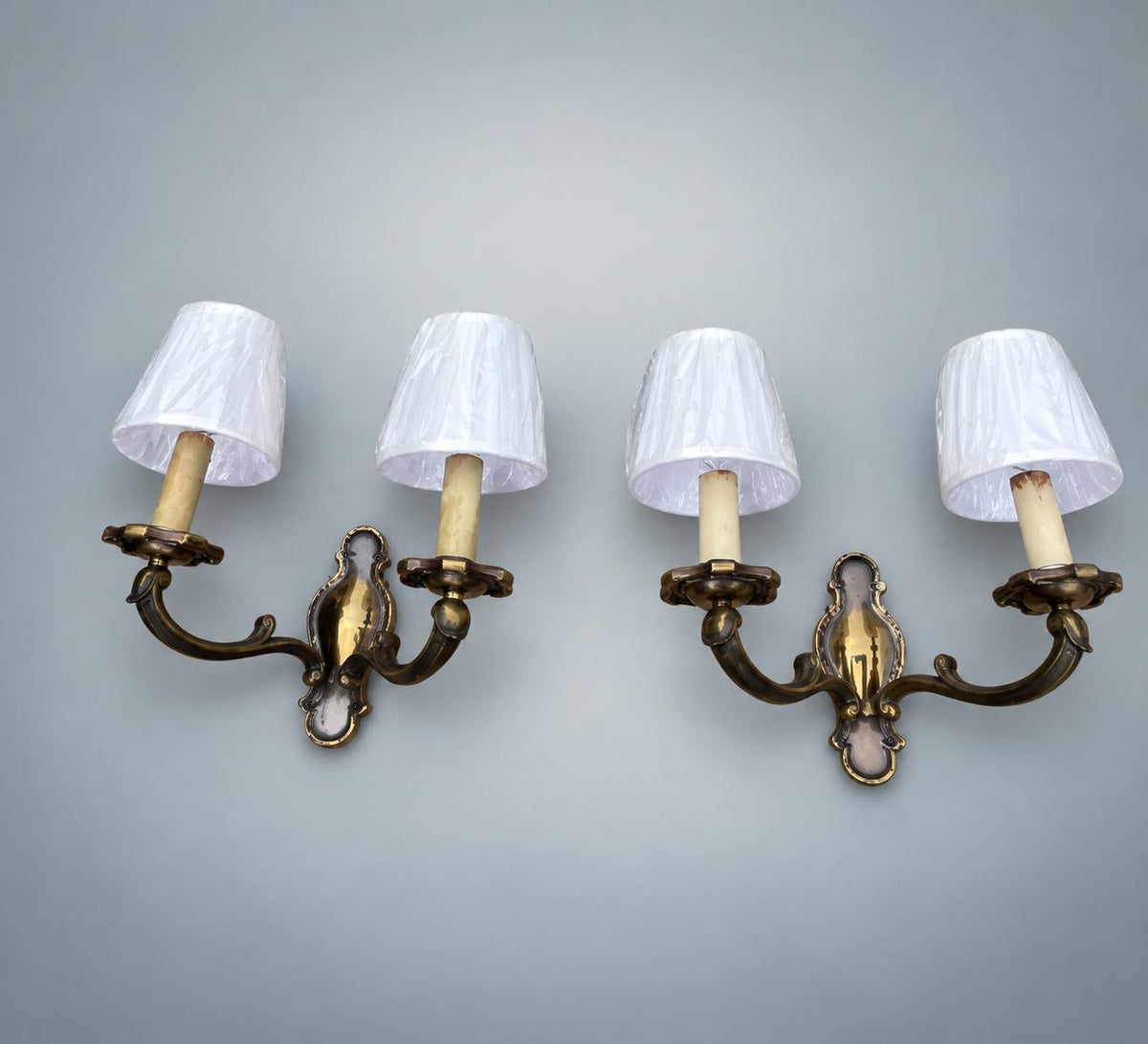 Pair of French Patinated Brass Two-Arm Wall Sconces, with White Fabric Shades — France, circa 1950