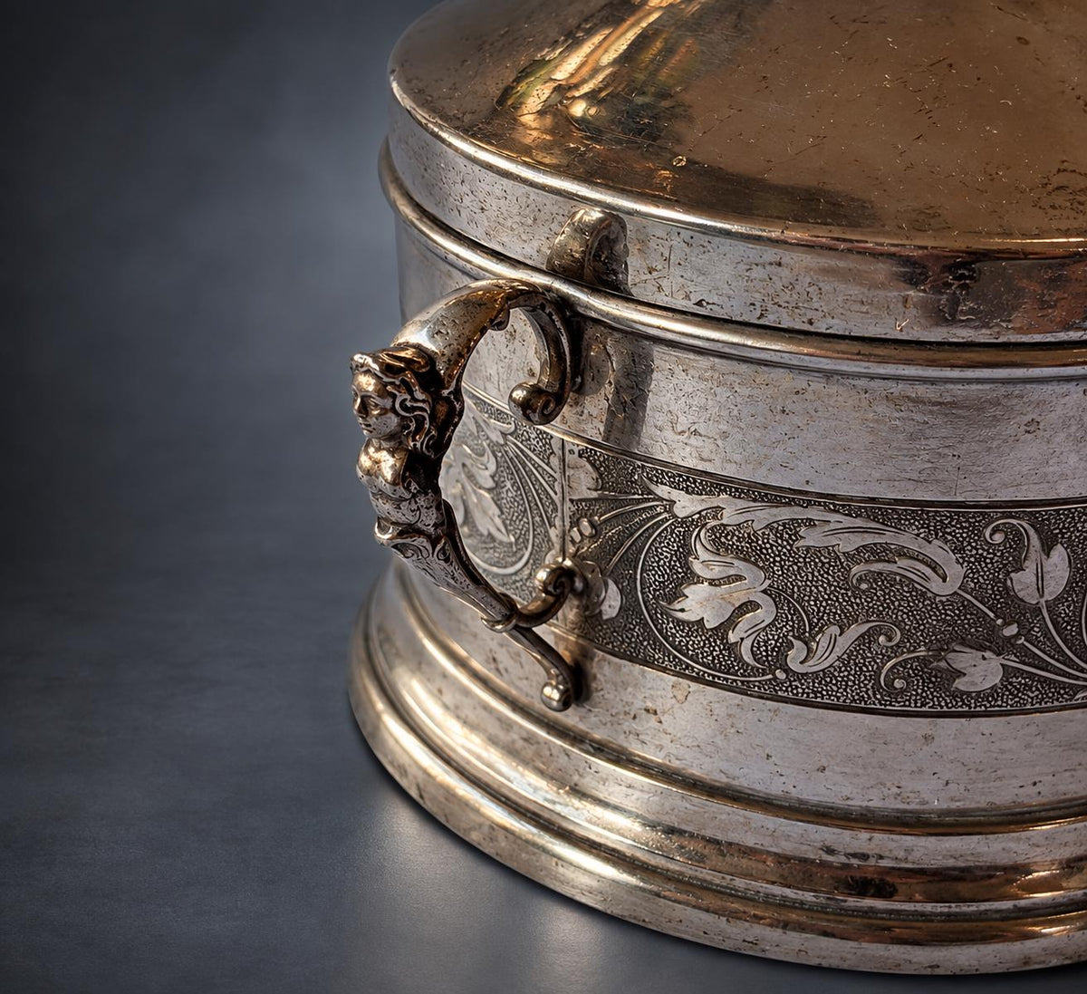 Lidded Bonbonnière in Silver-Tone Metal, Embossed Mask and Scroll Band, Figural Handles, Leaf Finial, Renaissance Revival Style