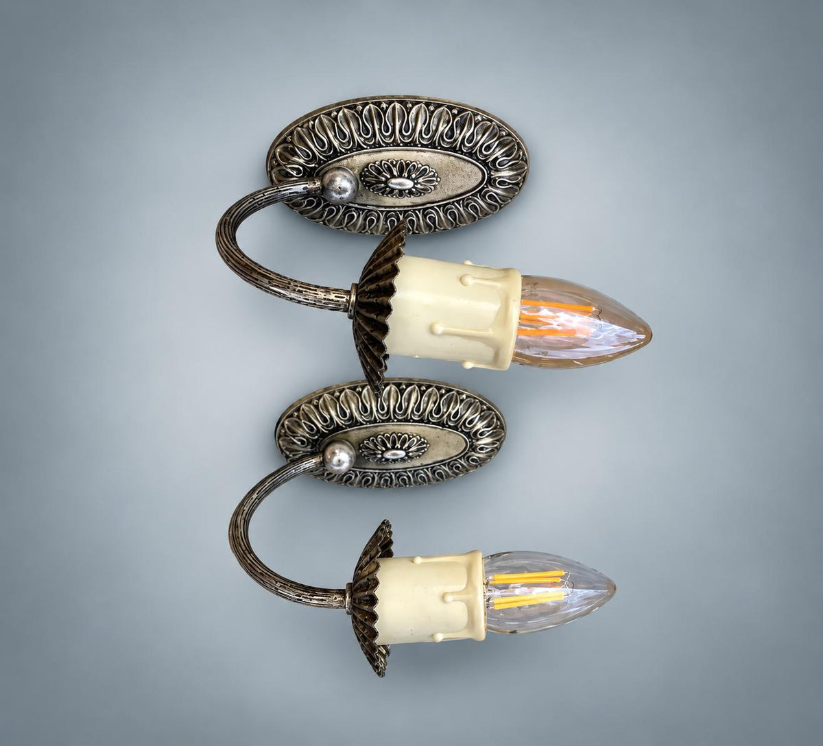 Pair of Vintage Silvered Metal Wall Sconces — Pierced Oval Backplate with Scrolled Ring Arm, Pleated Shades