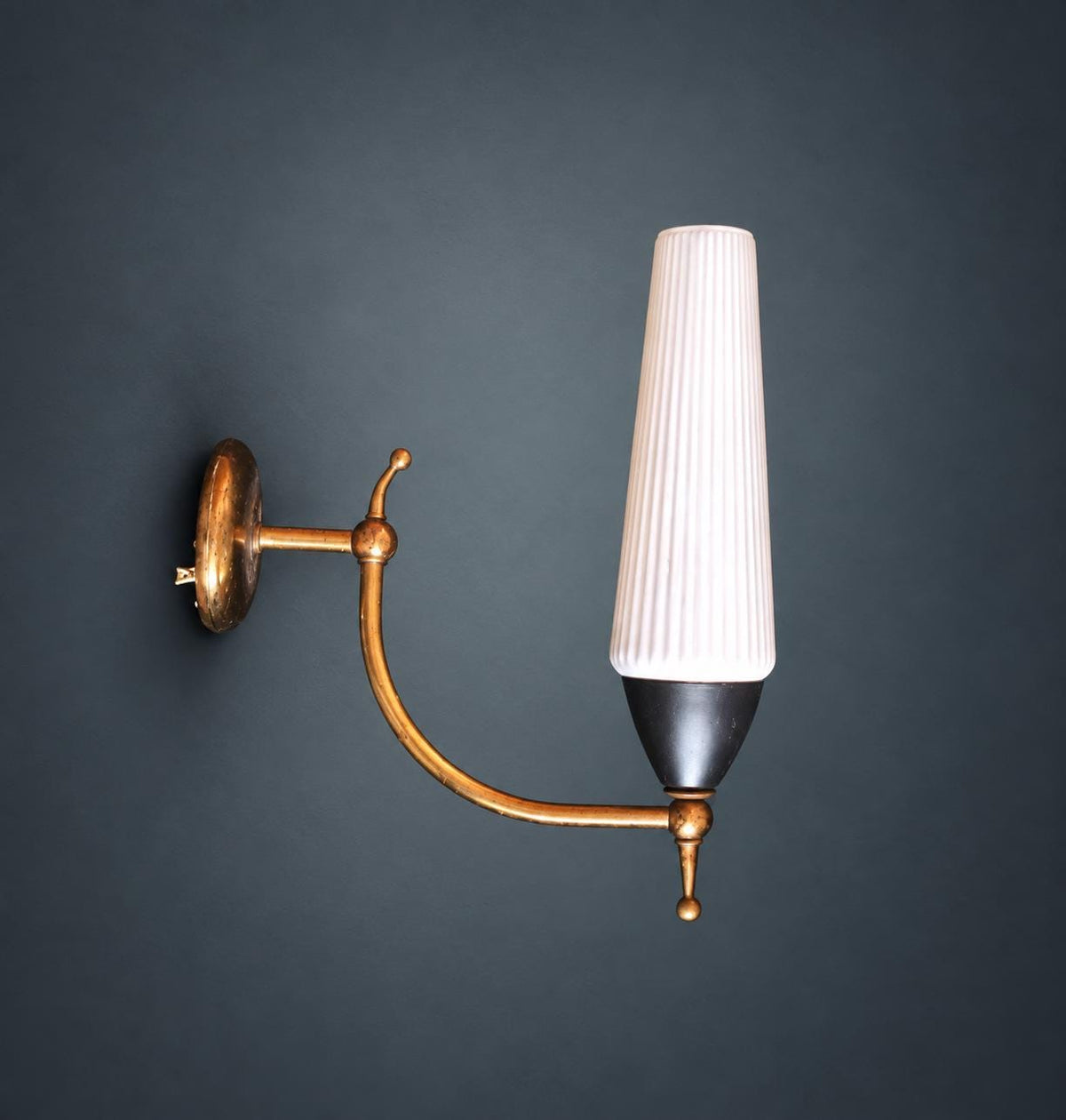 1950s Style Wall Sconce, Ribbed White Glass Shade, Curved Brass-Tone Arm with Ball Finials, Black Cup, Mid-Century Wall Light