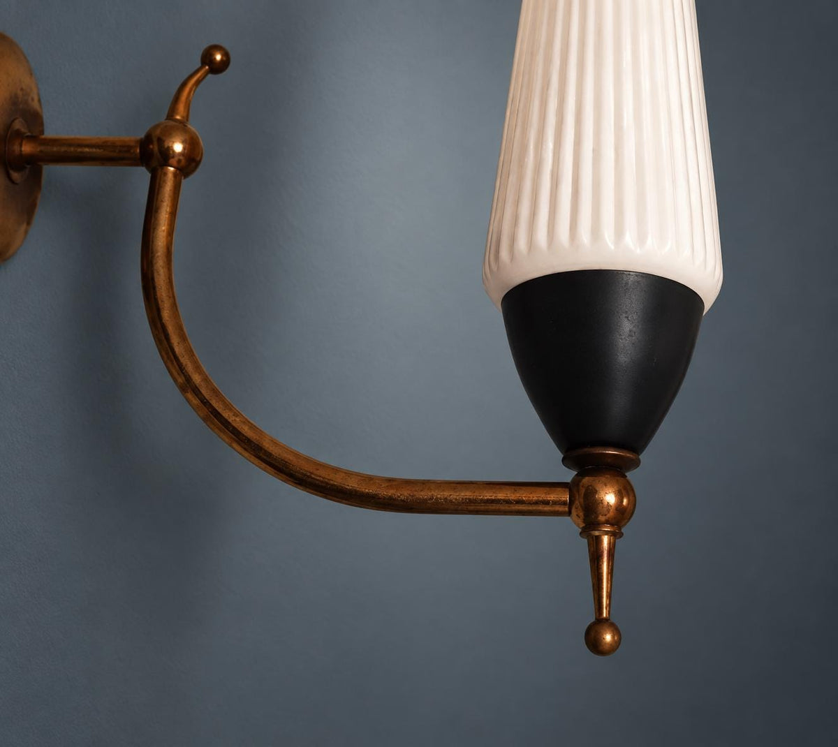 1950s Style Wall Sconce, Ribbed White Glass Shade, Curved Brass-Tone Arm with Ball Finials, Black Cup, Mid-Century Wall Light