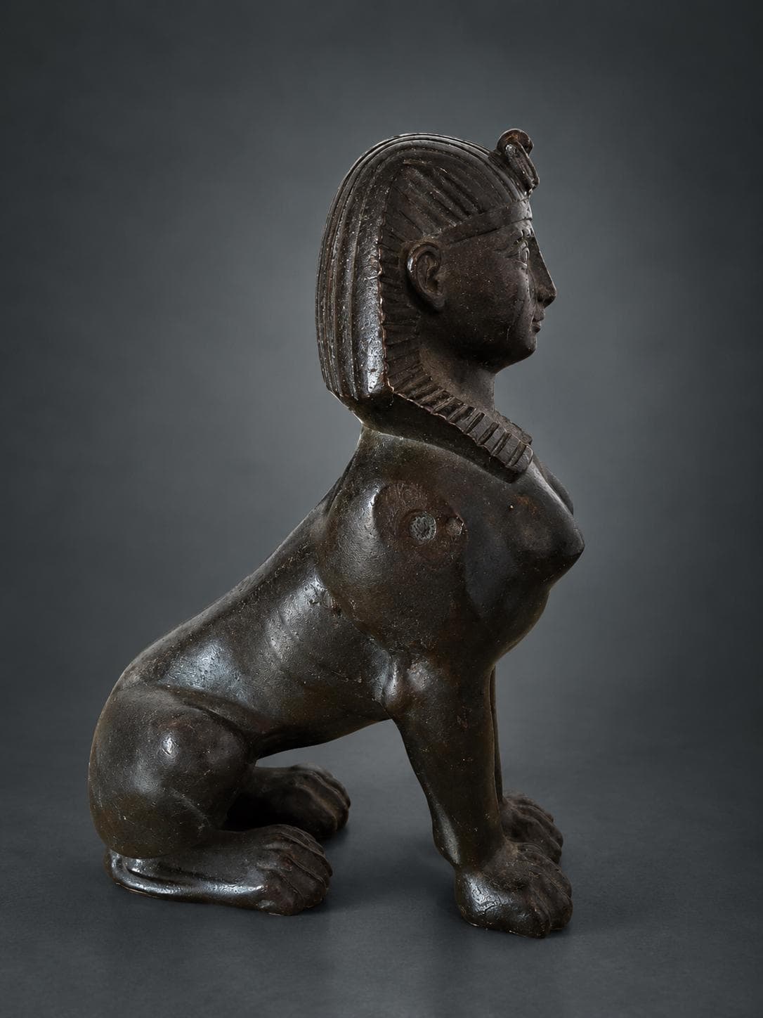 Egyptian Revival Style Seated Sphinx Figure, Dark Patinated Metal, Nemes Headdress, Former Clock or Furniture Mount