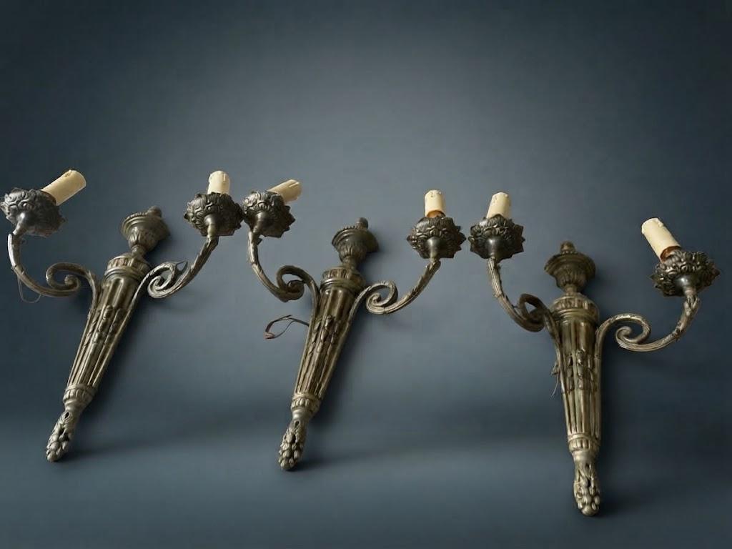 Set of Three Louis XVI Style Two-Arm Wall Sconces, Quiver Backplates with Ribbons, Leaf Cups and Pine Cone Drops