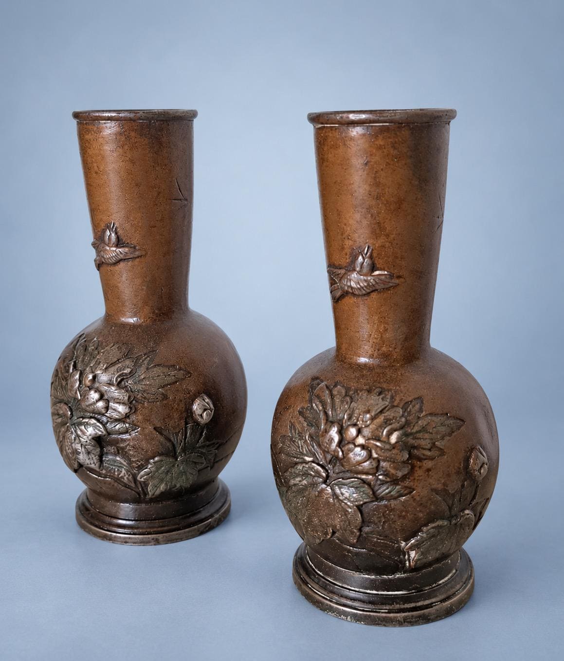 Antique Pair of Small Meiji Style Patinated Metal Bottle Vases, Peonies and Flying Birds in Relief