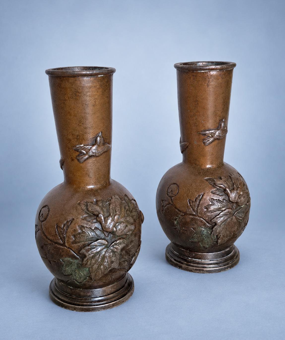 Antique Pair of Small Meiji Style Patinated Metal Bottle Vases, Peonies and Flying Birds in Relief