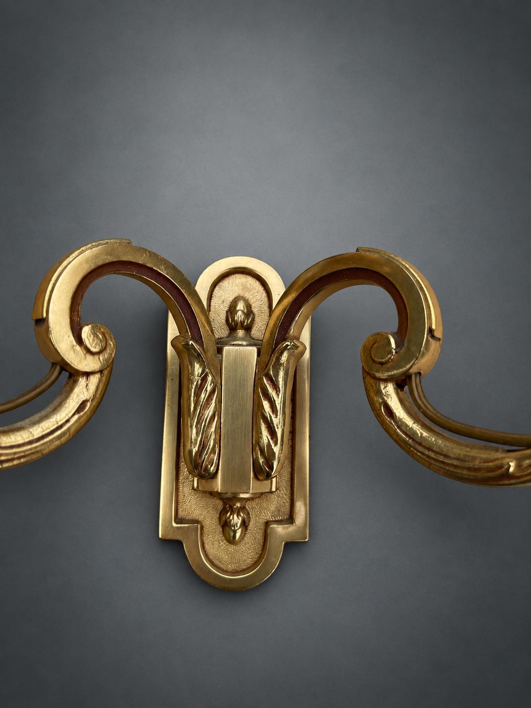 Pair of Gilt Metal Two-Arm Wall Sconces with Candle-Form Covers and Scrolled Arms