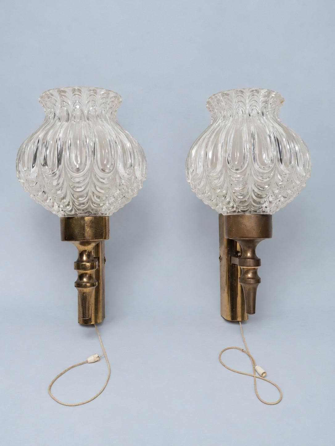 Vintage Pair of 1950s Brass-Tone Wall Sconces with Clear Teardrop-Pattern Glass Shades and Pull Cords