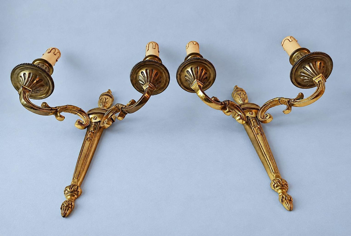 Antique Pair of Louis XVI Style Two-Arm Gilt Metal Torch Wall Sconces with Urn Finials and Beaded Drip Pans