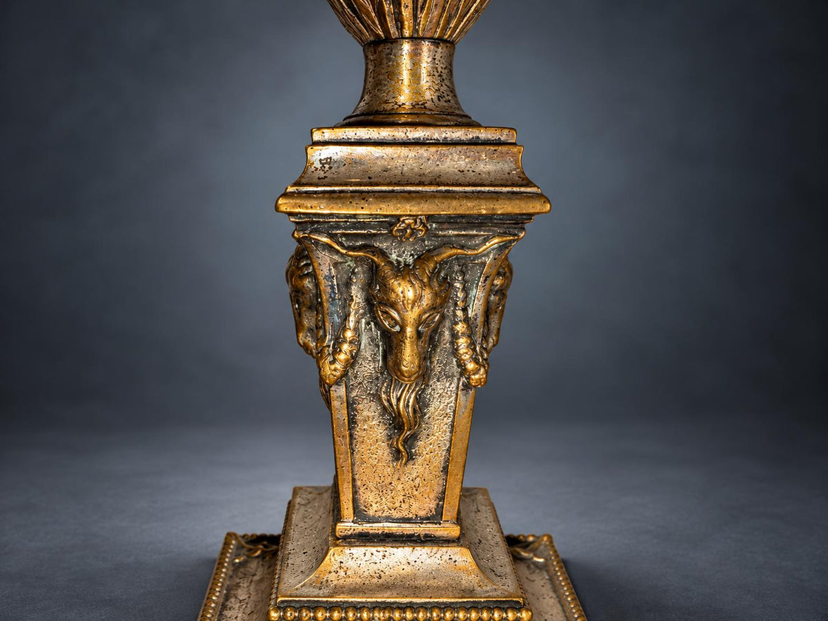 Pair of Neoclassical Candlesticks, Silver-Tone Metal with Ram's Heads and Garlands, Fluted Urn Sconces, Warm Worn Finish