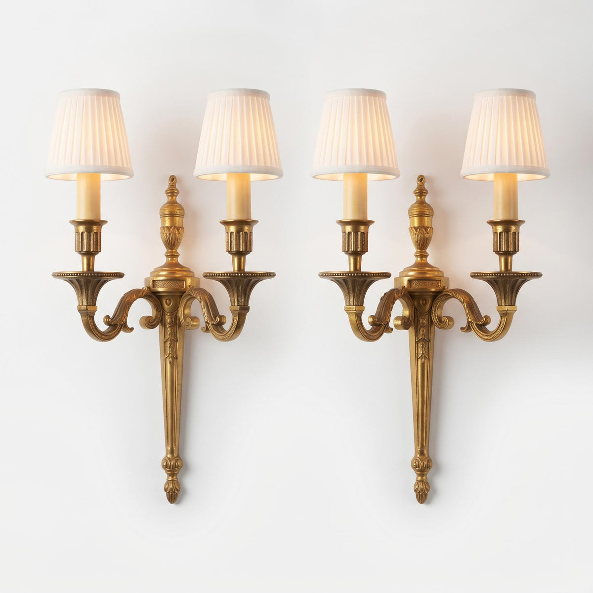 Antique Pair of Louis XVI Style Two-Arm Gilt Metal Torch Wall Sconces with Urn Finials and Beaded Drip Pans