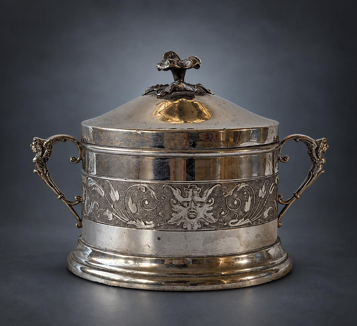 Lidded Bonbonnière in Silver-Tone Metal, Embossed Mask and Scroll Band, Figural Handles, Leaf Finial, Renaissance Revival Style