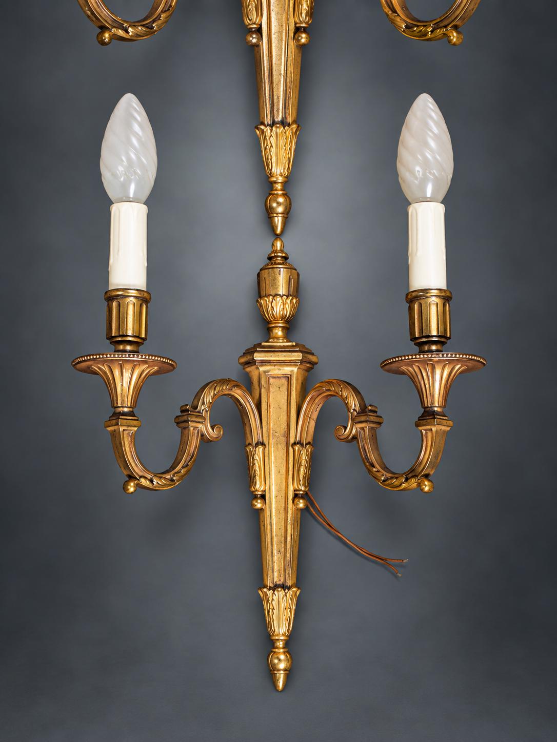 Pair of Louis XVI Style Two-Arm Wall Sconces, Gilt Metal with Urn Finials, Four Red Clip-On Shades with Gold Braid