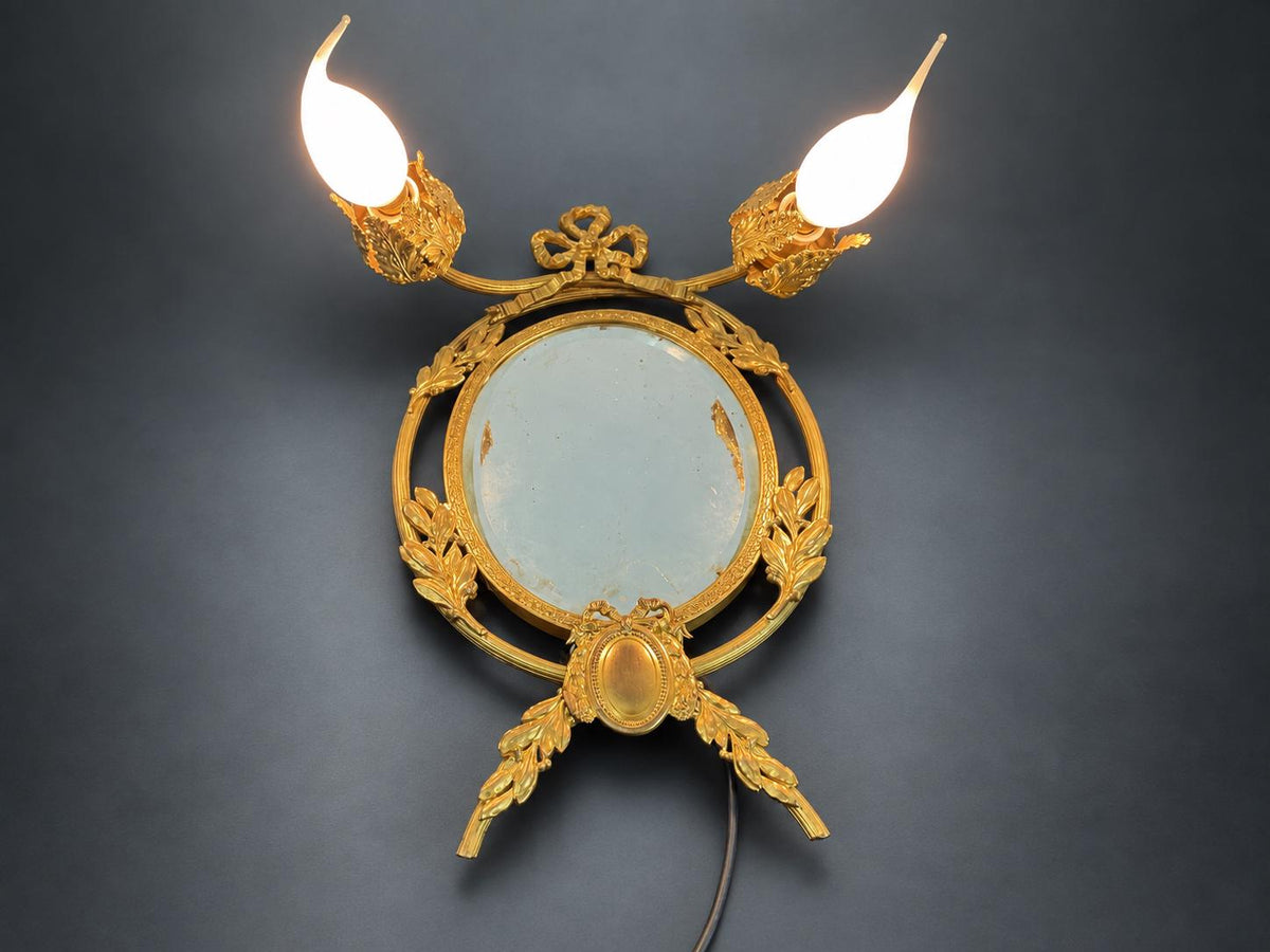 Louis XVI Style Mirrored Wall Sconce, Gilt Metal Girandole with Bevelled Oval Mirror, Ribbon Bow and Laurel, Two Lights