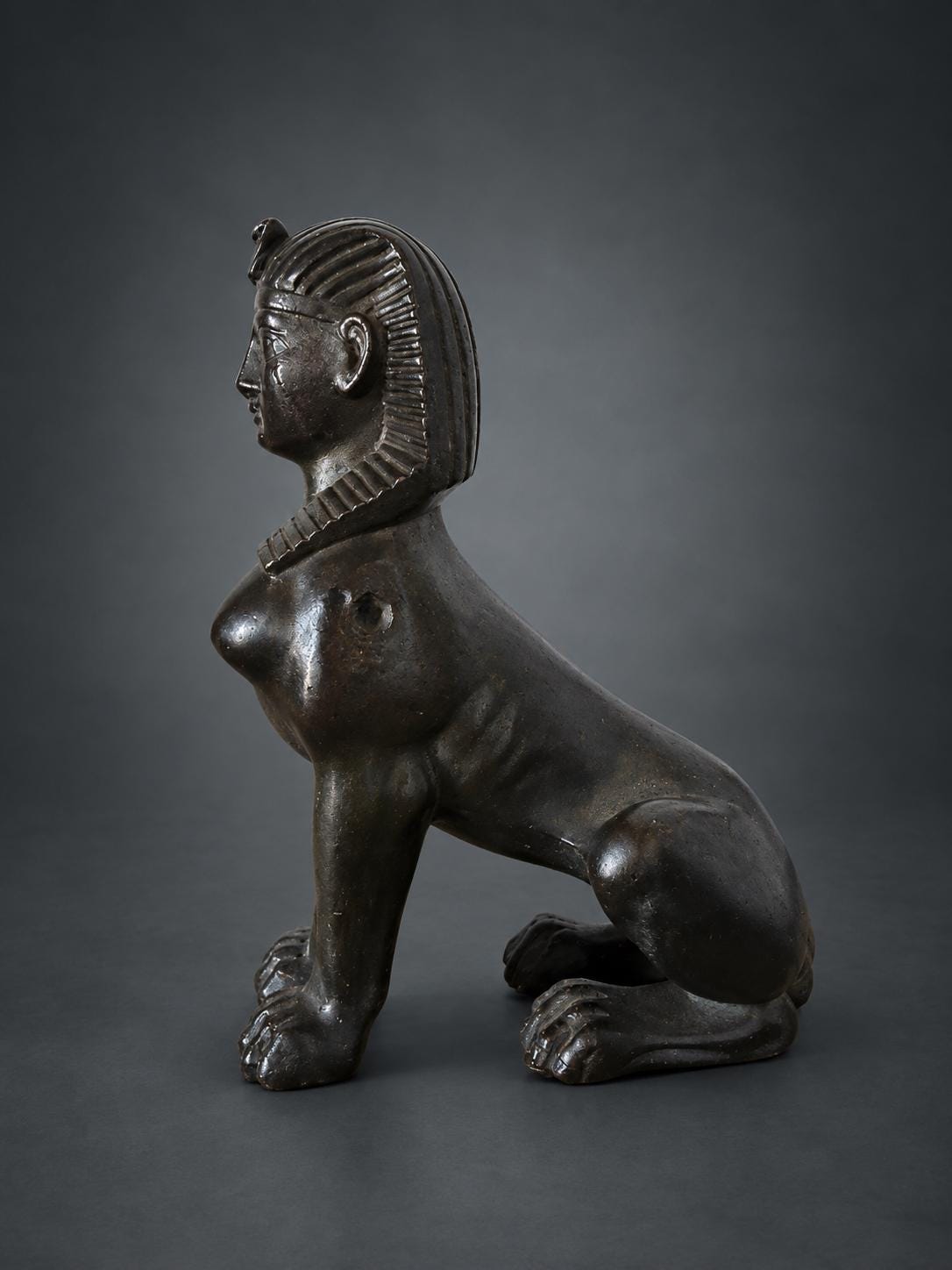 Egyptian Revival Style Seated Sphinx Figure, Dark Patinated Metal, Nemes Headdress, Former Clock or Furniture Mount
