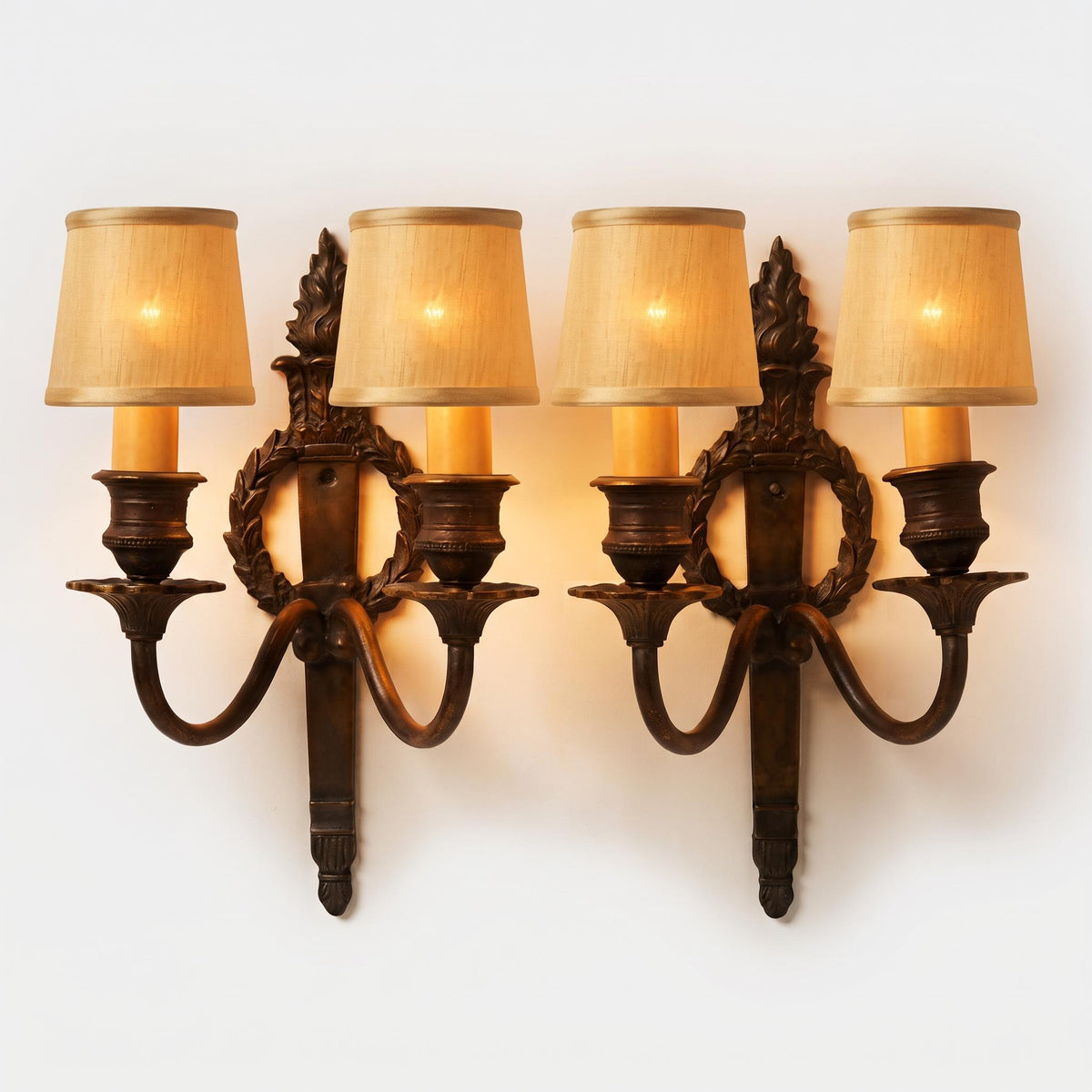 Pair of Louis XVI Style Two-Arm Wall Sconces, Bronze-Tone Patinated Metal with Laurel Wreath and Flame Finial