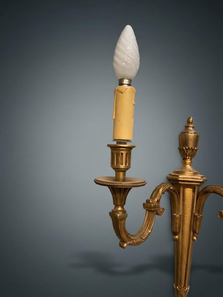 Pair of Louis XVI Style Two-Arm Wall Sconces, Gilt Metal with Scrolled Arms, Beaded Drip Pans and Urn Finials