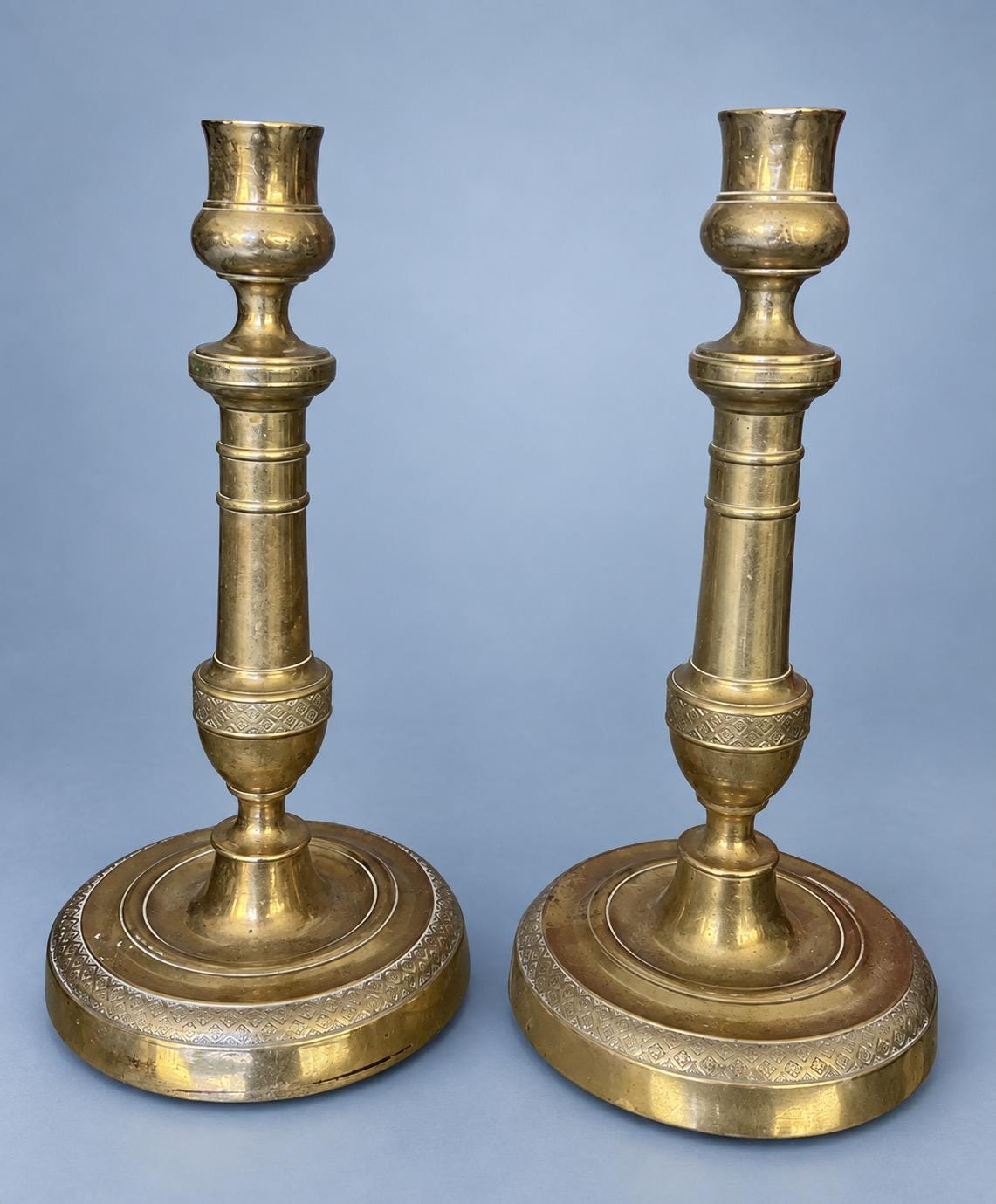 Antique Pair of Empire Style Brass-Tone Candlesticks with Ringed Shafts and Chased Diaper Bands, 19th Century