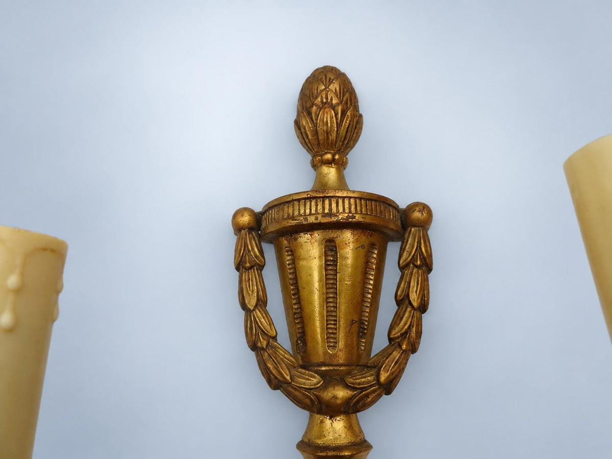 Vintage Pair of Louis XVI Style Gilt Metal Two-Arm Wall Sconces with Urn and Garland Crest