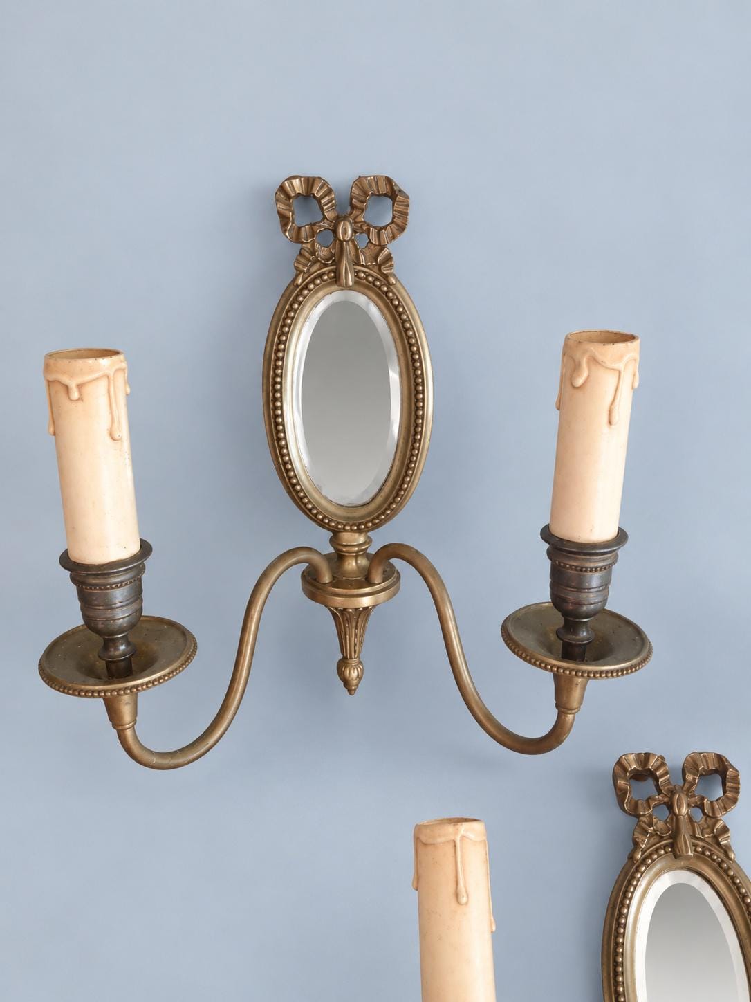 Vintage Pair of Louis XVI Style Two-Arm Wall Sconces with Oval Bevelled Mirrors and Ribbon Bows