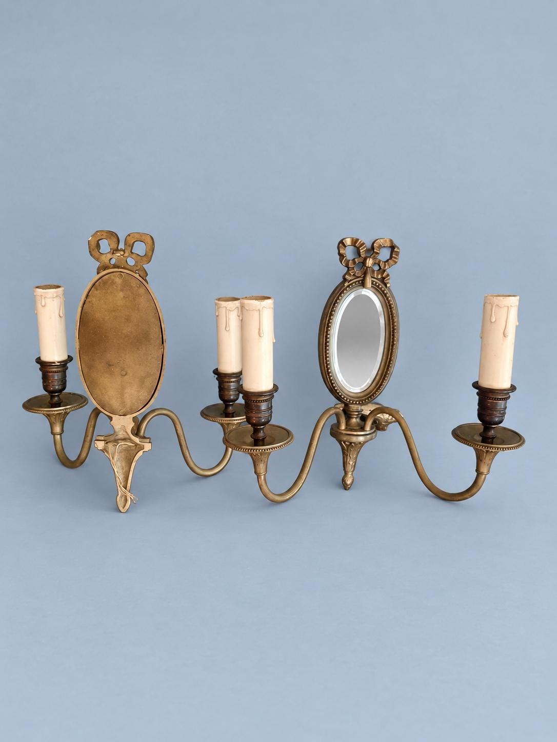 Vintage Pair of Louis XVI Style Two-Arm Wall Sconces with Oval Bevelled Mirrors and Ribbon Bows