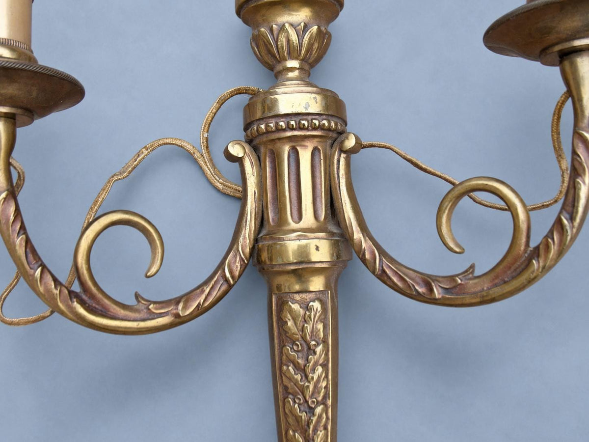 Vintage Pair of Louis XVI Style Brass-Tone Two-Arm Wall Sconces with Urn and Oak-Leaf Shaft