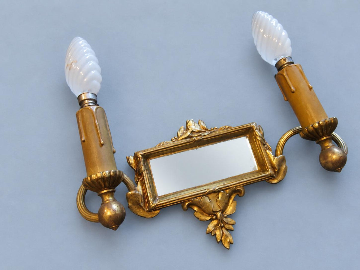 Vintage Pair of Louis XVI Style Two-Arm Gilt Metal Mirror Wall Sconces with Laurel Crests
