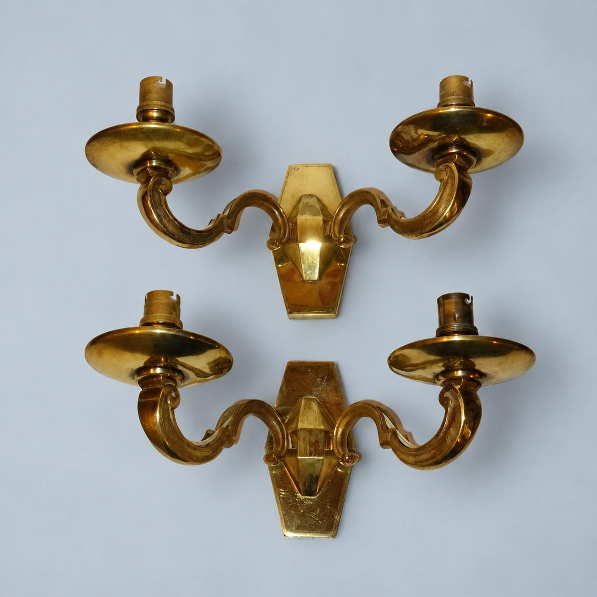 Vintage Pair of Louis XIV Style Polished Brass Wall Sconces, Faceted Backplates with Heavy Scroll Arms, Two Lights Each