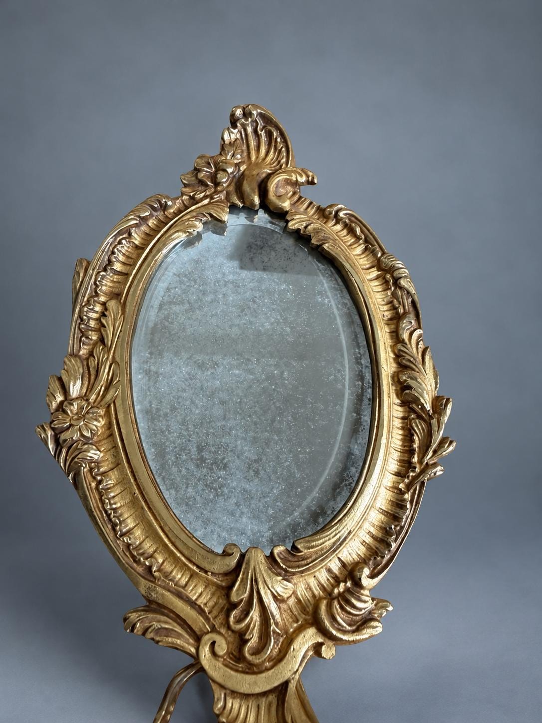 Vintage Pair of Rocaille Style Mirror Wall Sconces, Oval Bevelled Mirrors in Gilt Metal Frames, Leafy Two-Light Arms
