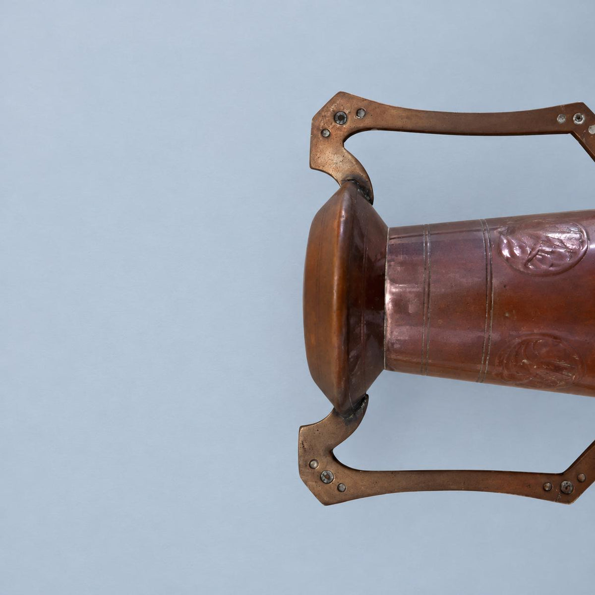 Vintage Art Nouveau Style Hammered Copper-Tone Vase with Angular Riveted Handles, Tall Tapering Form on Stepped Foot