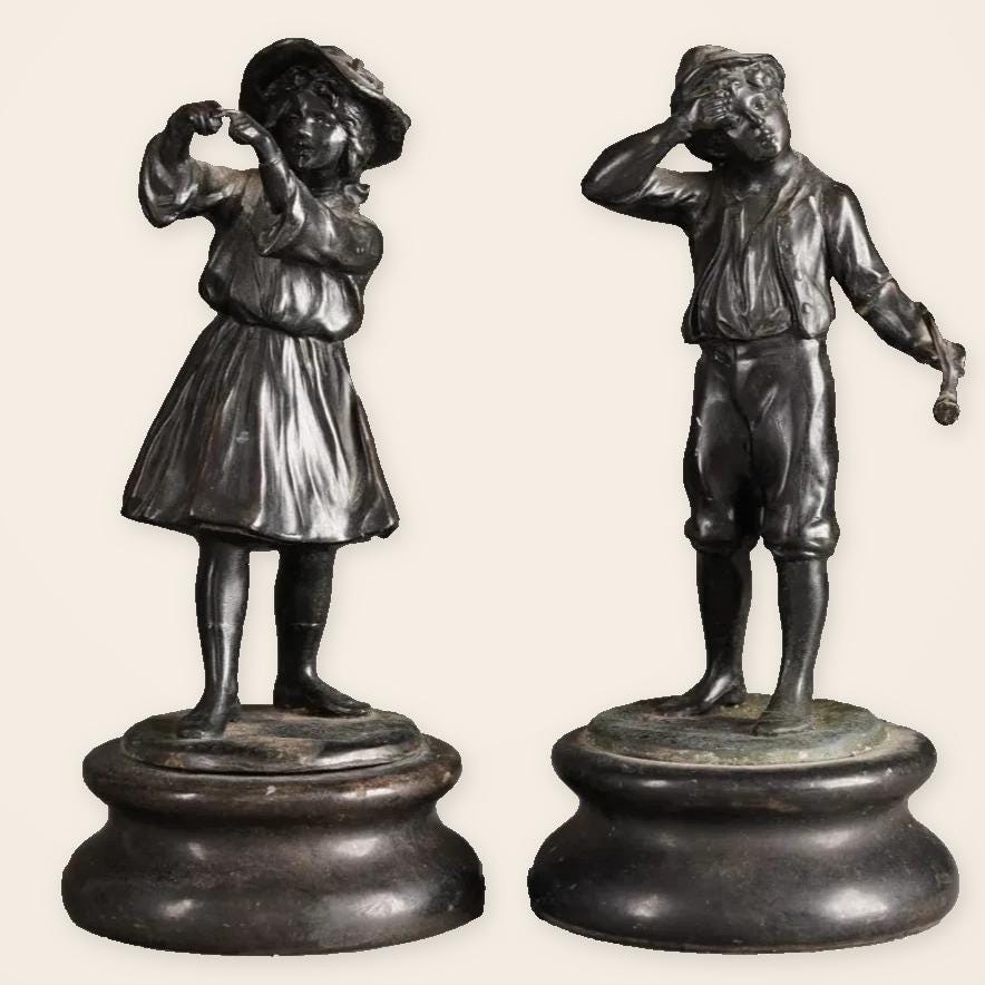 Pair of Antique Bronze Figures of Country Children, Girl in Bonnet and Boy Shading His Eyes, on Turned Bases, circa 1900