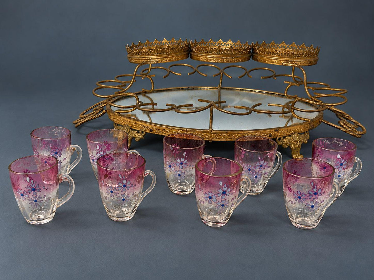 Antique Napoleon III Liqueur Set, Two Cranberry Enameled Glass Decanters and Cordial Glasses on Gilt Brass Mirrored Tray Stand