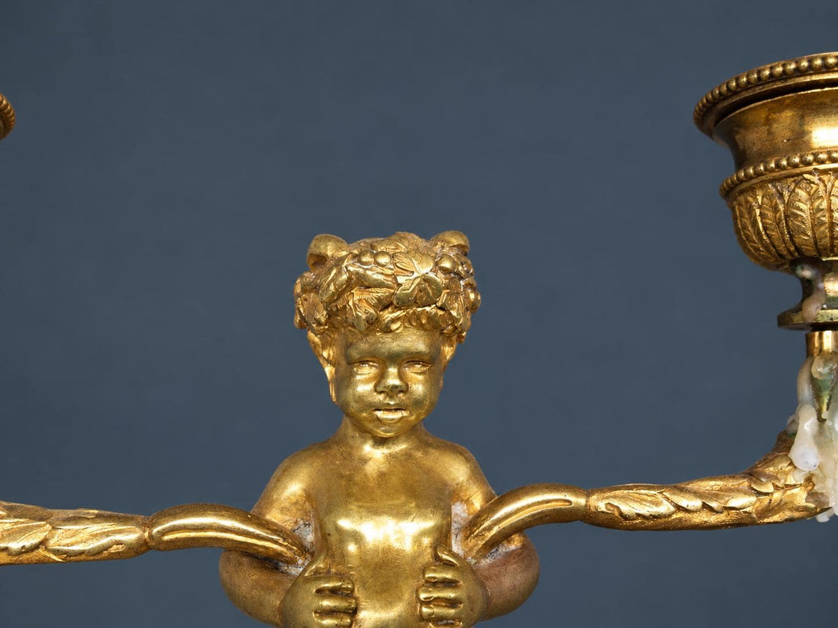 Pair of Antique Napoleon III Gilt Bronze Faun Candelabra, Young Satyrs Holding Laurel Garland Arms, White Marble Bases