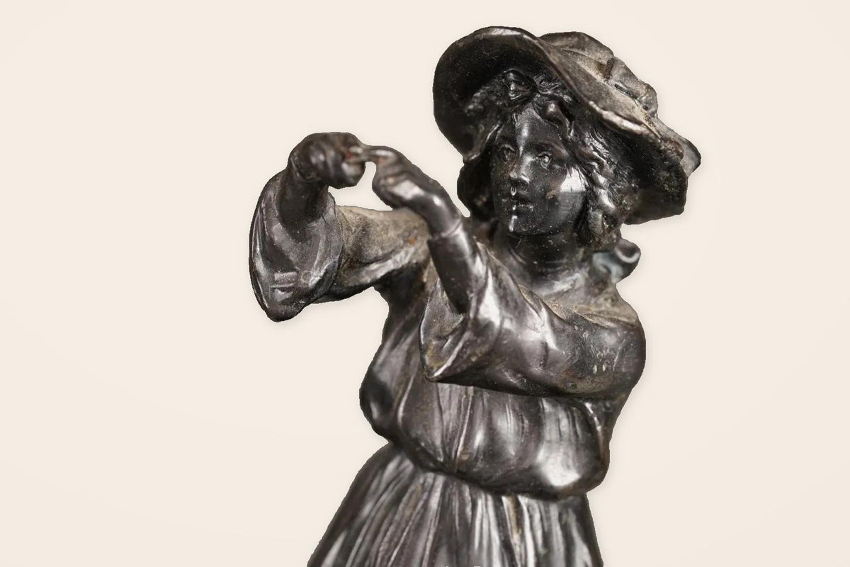 Pair of Antique Bronze Figures of Country Children, Girl in Bonnet and Boy Shading His Eyes, on Turned Bases, circa 1900
