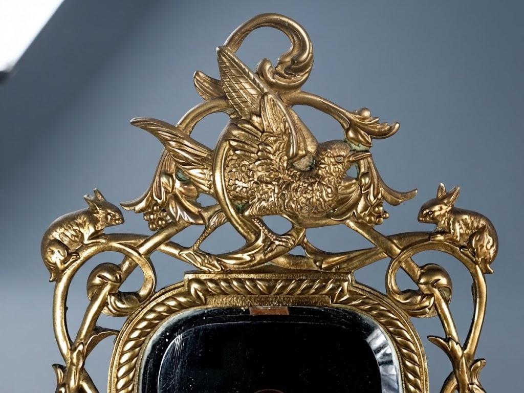 Pair of Antique Bronze Mirrored Wall Sconces, Three-Light Girandoles with Rabbits, Winged Bird Crest and Beveled Glass, 1890s
