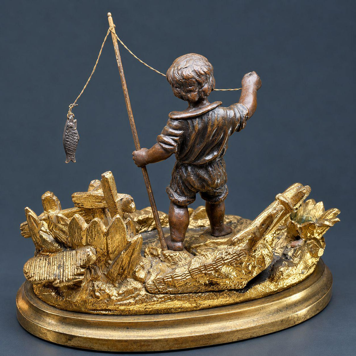 Antique 19th Century Gilt Bronze Match Holder, Young Boy Fishing with Rod and Fish on Reed-Covered Bank, Smoker’s Pyrogene