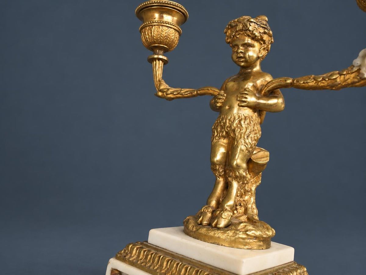 Pair of Antique Napoleon III Gilt Bronze Faun Candelabra, Young Satyrs Holding Laurel Garland Arms, White Marble Bases