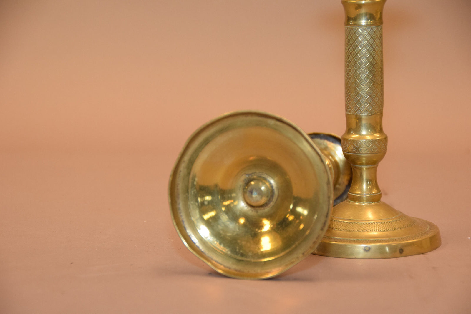 Pair of antique bronze candlesticks with intricate detailing, crisscross diamond texture, and a rich aged patina. Elegant and timeless, these vintage candle holders are perfect for dining tables, mantels, or decorative displays. Crafted with sturdy bronze construction, they add sophistication to any space. A must-have for antique collectors and lovers of classic home decor.