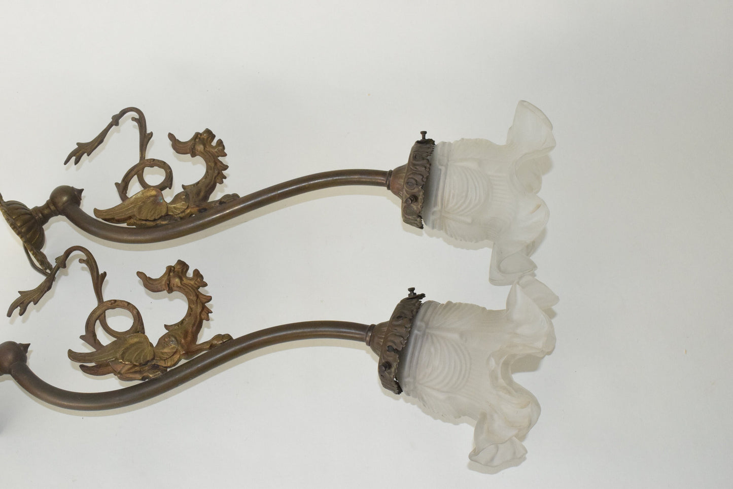 A Pair of Antique bronze wall lights