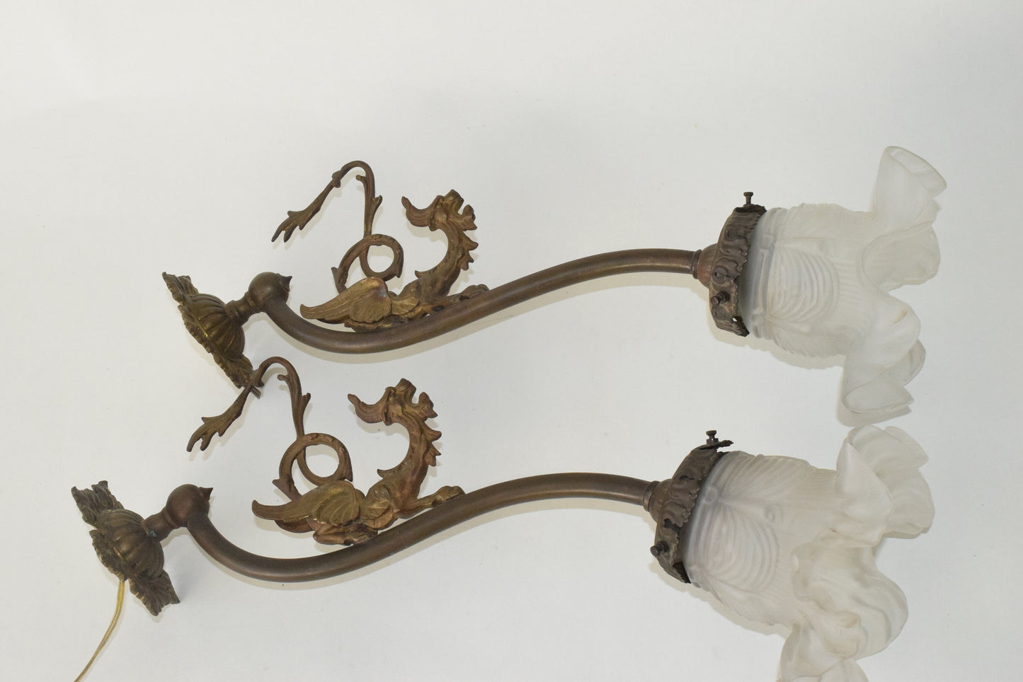 A Pair of Antique bronze wall lights