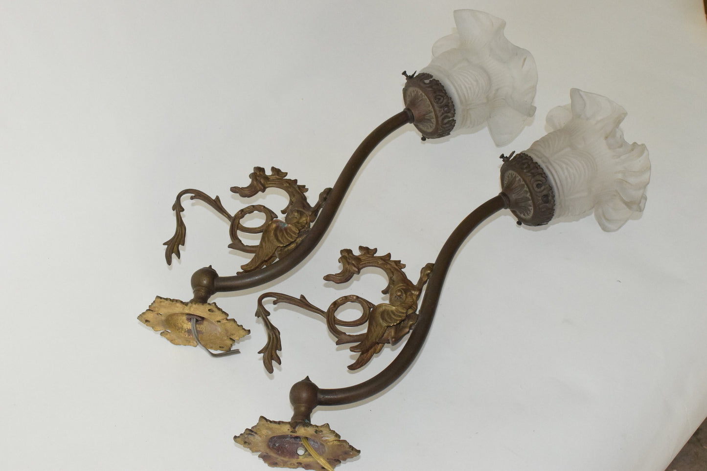 A Pair of Antique bronze wall lights