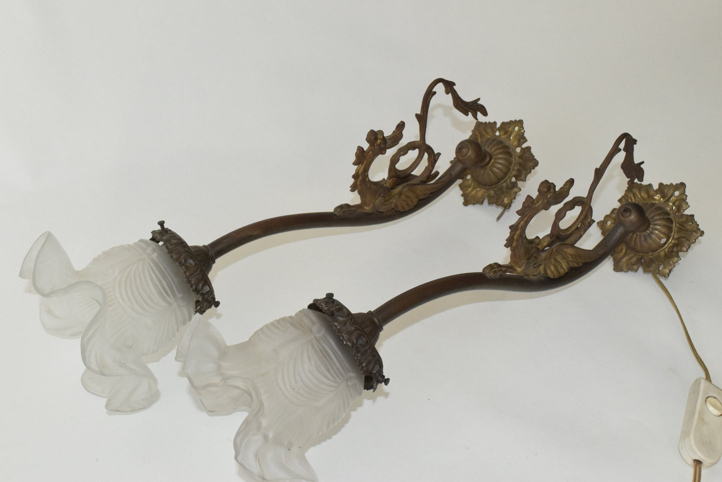 A Pair of Antique bronze wall lights