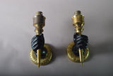 Pair of Art Deco solid brass wall sconces from the 1930s featuring a fist holding torch design, ideal for vintage and antique home décor.